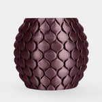 A small round ceramic pot with a textured, overlapping leaf or scale pattern in a deep plum purple color, set against a plain light gray background.