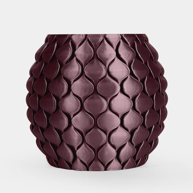 A small round ceramic pot with a textured, overlapping leaf or scale pattern in a deep plum purple color, set against a plain light gray background.