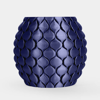 A glossy dark blue textured planter pot with a raised leaf-like pattern, centered on a light gray background.