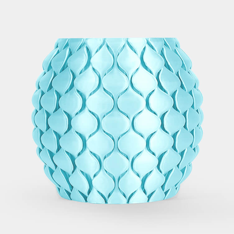 A light blue ceramic planter with a textured, overlapping leaf or scale pattern, centered on a clean white background.